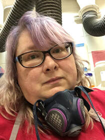 Photo of Lisa Carnell wearing a respirator mask around her neck
